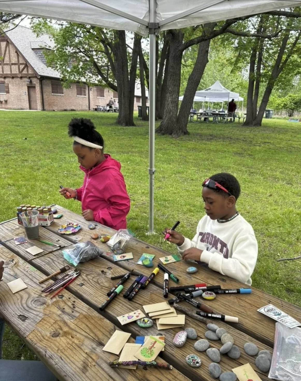Children painting rocks at the Eggers Grove Nature Block Party